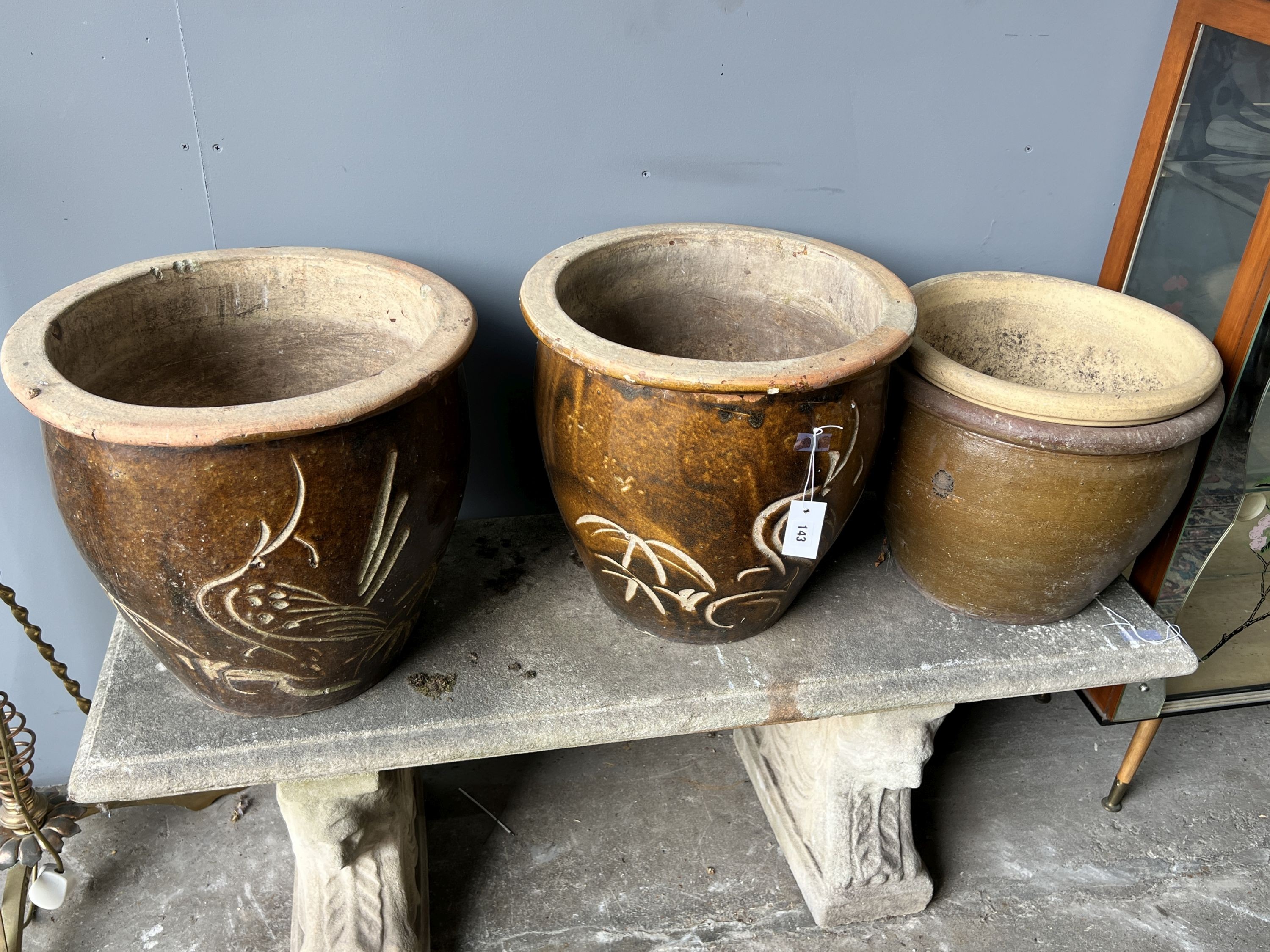 Four circular glazed earthenware garden planters, largest diameter 42cm and height 39cm